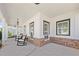 Inviting front porch featuring rocking chairs, brick accents, and stylish lighting fixtures at 4044 Andover Cir, Mcdonough, GA 30252