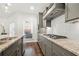 Modern kitchen featuring gray cabinets, granite countertops, and stainless steel appliances at 4044 Andover Cir, Mcdonough, GA 30252