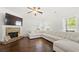 Bright and spacious living room featuring a fireplace and a comfortable sectional sofa at 4044 Andover Cir, Mcdonough, GA 30252