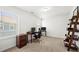 Office space with two desks and computer, two windows allowing natural light, and neutral colored carpet at 4044 Andover Cir, Mcdonough, GA 30252