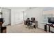Office space with desk and computer, two windows allowing natural light, and neutral colored carpet at 4044 Andover Cir, Mcdonough, GA 30252