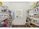 Walk-in pantry with shelving and a window for natural light at 4044 Andover Cir, Mcdonough, GA 30252