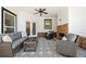 Relaxing covered patio with an outdoor fireplace, ceiling fan, and stylish outdoor seating for entertaining at 4044 Andover Cir, Mcdonough, GA 30252