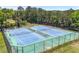 Aerial view of the community's tennis courts surrounded by lush trees, offering a recreational amenity at 4044 Andover Cir, Mcdonough, GA 30252