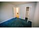 Cozy bedroom with two closets, blue carpet, and a doorway to a bathroom at 4190 Heather Way, Cumming, GA 30041