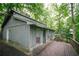 Charming single-story home featuring a spacious deck surrounded by lush trees at 4190 Heather Way, Cumming, GA 30041