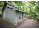 Single-story home featuring a spacious deck and surrounded by mature trees at 4190 Heather Way, Cumming, GA 30041