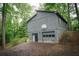 Two-story home featuring a two-car garage and basketball hoop surrounded by trees at 4190 Heather Way, Cumming, GA 30041