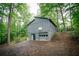 Two-story home featuring a two-car garage and basketball hoop surrounded by trees at 4190 Heather Way, Cumming, GA 30041