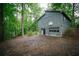 Two-story home featuring a two-car garage and basketball hoop surrounded by trees at 4190 Heather Way, Cumming, GA 30041