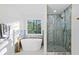 Bright bathroom features a soaking tub, marble walk-in shower, and natural light at 139 Thunder Ridge Ln, Acworth, GA 30101
