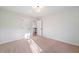 Empty bedroom featuring neutral carpet, overhead lighting, and views of the upstairs hallway at 139 Thunder Ridge Ln, Acworth, GA 30101