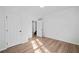 Simple bedroom space with light wood floors, white walls, and multiple doorways at 139 Thunder Ridge Ln, Acworth, GA 30101