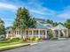 View of clubhouse with stone and siding and manicured landscaping and plenty of parking at 139 Thunder Ridge Ln, Acworth, GA 30101