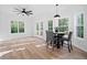 Bright dining area featuring modern decor, hardwood floors, and a view of the wooded backyard at 139 Thunder Ridge Ln, Acworth, GA 30101