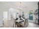Dining room boasts a stylish marble table, hardwood floors, and modern light fixture at 139 Thunder Ridge Ln, Acworth, GA 30101
