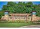 Stone entrance to Bentwater community with lush landscaping and signage, offering a welcoming ambiance at 139 Thunder Ridge Ln, Acworth, GA 30101