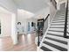 Bright foyer featuring a staircase, hardwood floors, and views of the entryway and dining area at 139 Thunder Ridge Ln, Acworth, GA 30101
