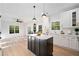 Bright open kitchen with white cabinets, marble countertops, black island, and stainless steel appliances at 139 Thunder Ridge Ln, Acworth, GA 30101