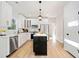 Bright open kitchen with white cabinets, marble countertops, black island, and stainless steel appliances at 139 Thunder Ridge Ln, Acworth, GA 30101