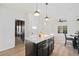 Bright kitchen featuring white cabinets, marble countertops, black island, and stainless steel appliances at 139 Thunder Ridge Ln, Acworth, GA 30101