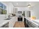 Modern kitchen boasts white cabinetry, stainless steel appliances, and hardwood floors at 139 Thunder Ridge Ln, Acworth, GA 30101