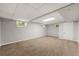 Finished basement with carpet flooring, a drop ceiling, and natural light through the windows at 1415 Hialeah Ct, Marietta, GA 30062