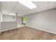 Open finished basement with carpet flooring and a slider to the exterior, letting in light at 1415 Hialeah Ct, Marietta, GA 30062