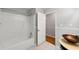Bright bathroom with shower and view of sink and wood-look flooring at 1415 Hialeah Ct, Marietta, GA 30062