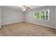 Spacious bedroom featuring a ceiling fan and large window at 1415 Hialeah Ct, Marietta, GA 30062
