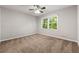 Cozy bedroom featuring plush carpeting, natural light from two windows, and a ceiling fan at 1415 Hialeah Ct, Marietta, GA 30062