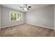 Bright bedroom with a ceiling fan, carpet, and a window view of the outdoors at 1415 Hialeah Ct, Marietta, GA 30062