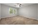 Bright bedroom featuring a ceiling fan, carpeted floors, and ample natural light through a window at 1415 Hialeah Ct, Marietta, GA 30062