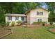 Inviting home featuring a well-maintained lawn, stone accents, and blue shutters at 1415 Hialeah Ct, Marietta, GA 30062