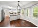 Bright kitchen with an island, gray cabinets, and stainless appliances, flowing into the dining space at 1415 Hialeah Ct, Marietta, GA 30062
