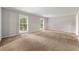 Bright, spacious living room featuring neutral paint and plush carpeting, illuminated by natural light at 1415 Hialeah Ct, Marietta, GA 30062