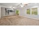 Open living room design with carpeted floors, staircase, and sliding glass door to the outdoors at 1415 Hialeah Ct, Marietta, GA 30062