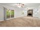 Spacious living room featuring a stone fireplace, ceiling fan, and access to the screened-in porch at 1415 Hialeah Ct, Marietta, GA 30062