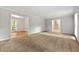 Open living room with carpet, natural light, and views to the dining area and staircase at 1415 Hialeah Ct, Marietta, GA 30062