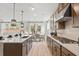 Modern kitchen featuring an island, pendant lighting, stone countertops, and stainless-steel appliances at 4014 Dantry Ln, Buford, GA 30519