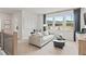 Neutral-toned living room with large windows, a comfortable couch, and modern decor at 4014 Dantry Ln, Buford, GA 30519