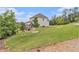 Expansive green backyard with mature trees and a wooden deck at 3139 Hilltop Drive, Marietta, GA 30066