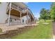 A tiered backyard features a retaining wall and a wooden deck at 3139 Hilltop Drive, Marietta, GA 30066