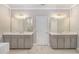 Bright bathroom featuring dual vanities with framed mirrors and white marble floors at 3139 Hilltop Drive, Marietta, GA 30066