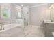 Luxurious bathroom with soaking tub, glass shower, marble tile and dual sinks at 3139 Hilltop Drive, Marietta, GA 30066