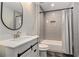 Charming bathroom with gray brick tiled shower-tub combo, and modern sink and vanity at 3139 Hilltop Drive, Marietta, GA 30066