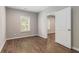 Bedroom with hardwood floors, a window, and a white open doorway at 3139 Hilltop Drive, Marietta, GA 30066
