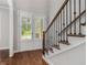 Elegant foyer with hardwood floors and a view to the front yard through shuttered glass doors at 3139 Hilltop Drive, Marietta, GA 30066