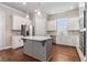 Modern kitchen features white cabinets, stainless steel appliances, an island and hardwood floors at 3139 Hilltop Drive, Marietta, GA 30066