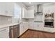 Modern kitchen featuring stainless steel appliances, white cabinets, and quartz countertops at 3139 Hilltop Drive, Marietta, GA 30066